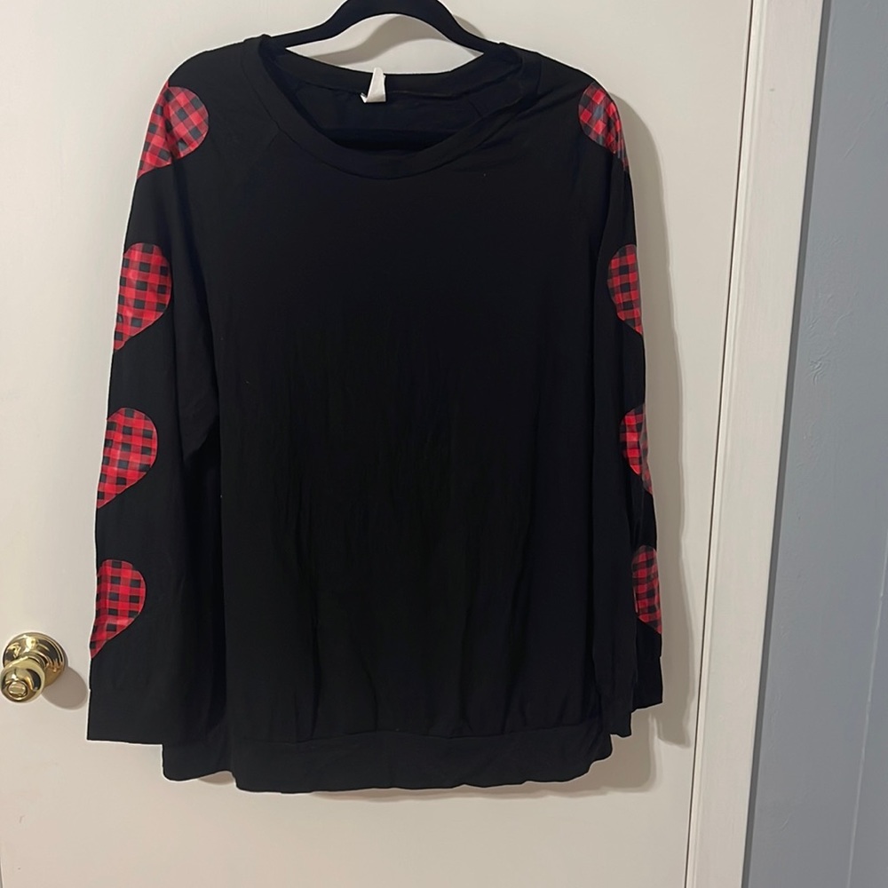 Sunshine and Rodeo black top with buffalo print hearts on the sleeves